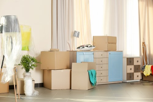 Professional movers handling office equipment