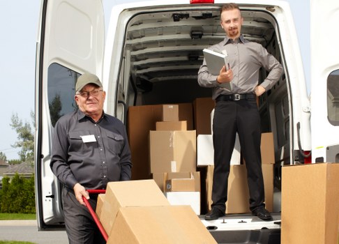 Professional movers organizing belongings in a Wimbledon storage unit