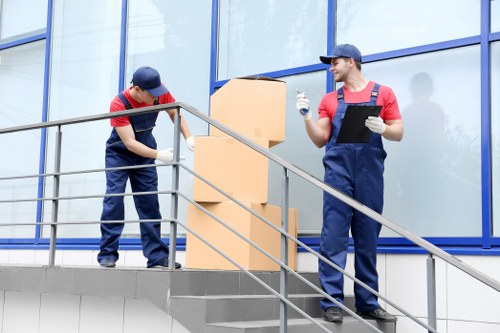Professional movers handling office equipment during a commercial move in Wimbledon